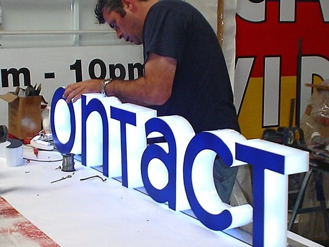 Technician working on the wiring of illuminated 3D letters