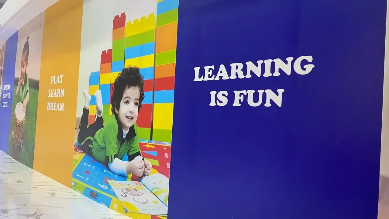 Large printed feature wall graphics with a bold headline and colourful illustration across a long indoor wall