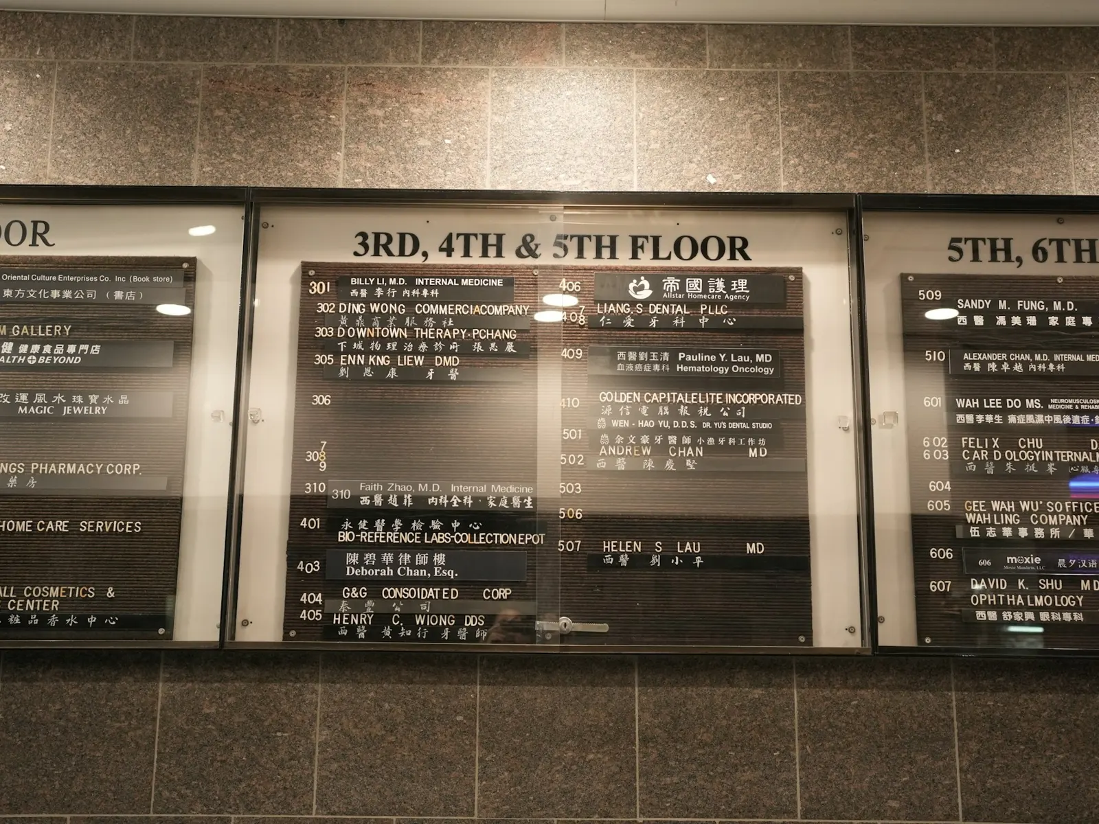 Building directory board listing tenants by floor on a lobby wall