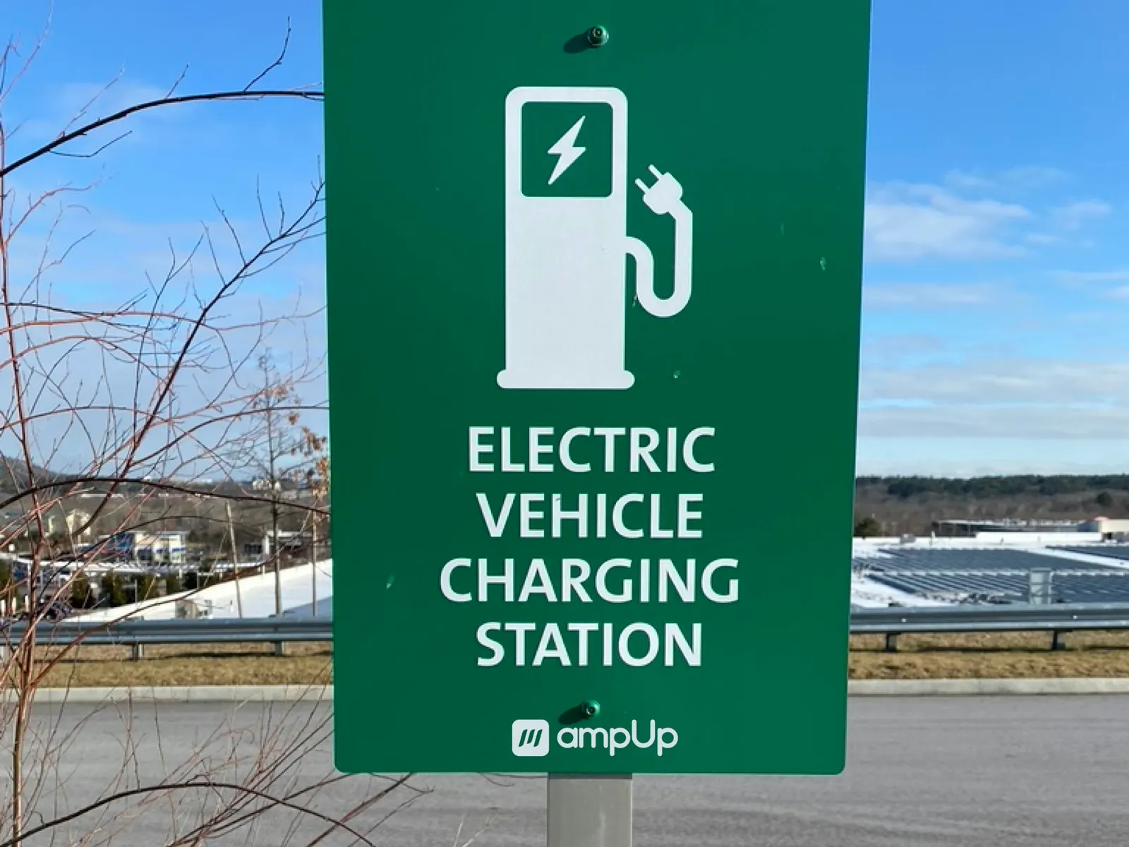 Green EV charging parking sign marking an electric vehicle charging station bay