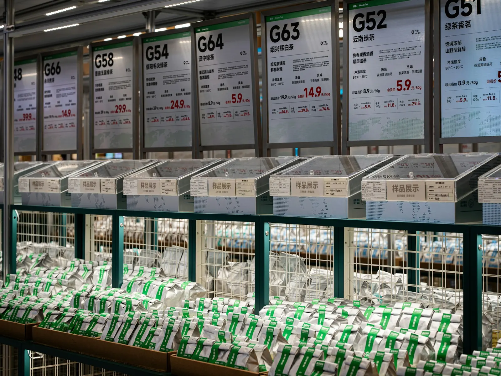 Row of numbered price display signs above produce bins in a supermarket aisle