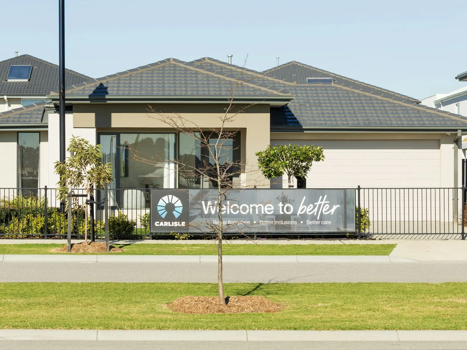 Show villa with a welcome sign banner on the fence of a new home