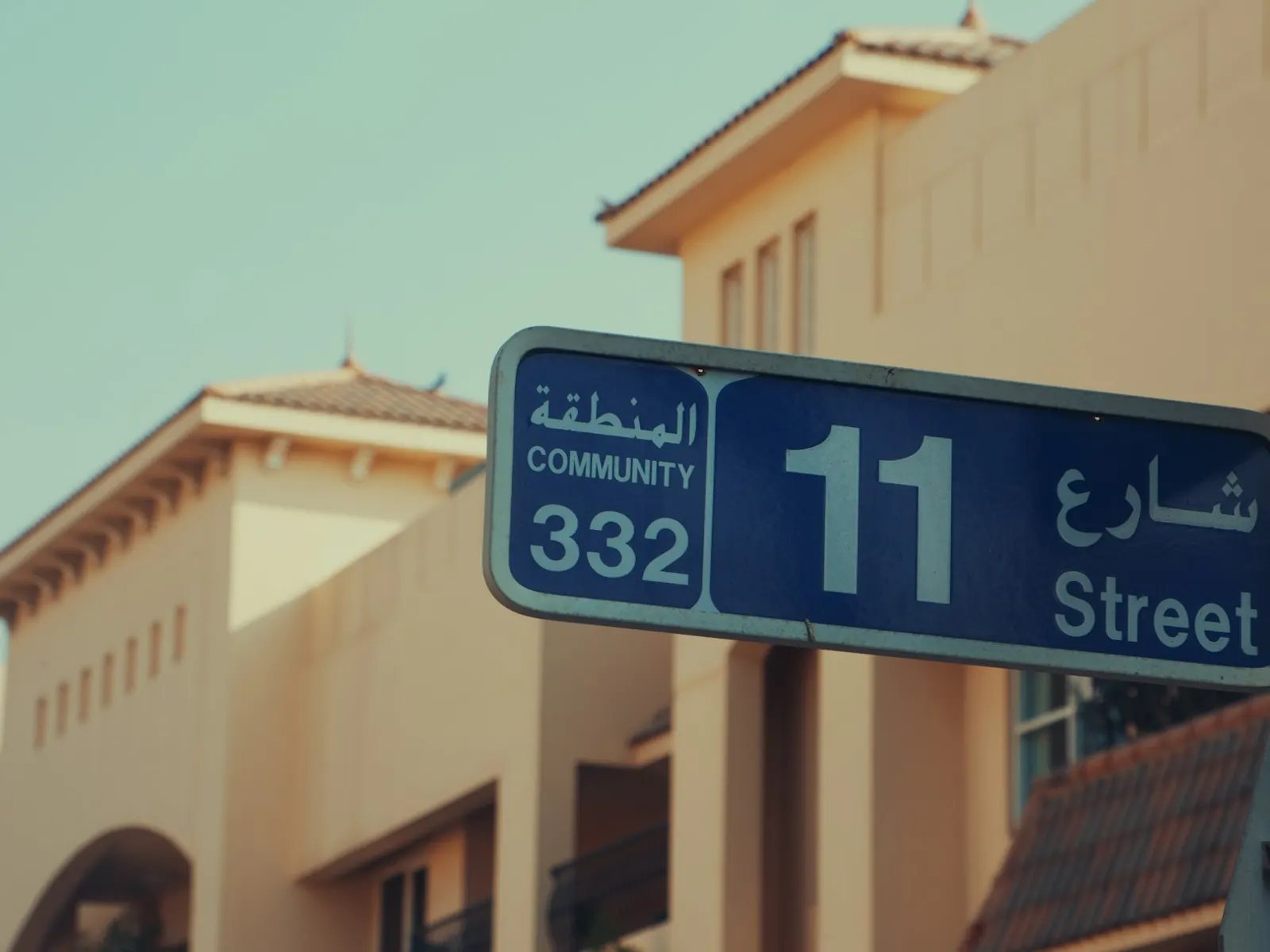 Bilingual Arabic and English street name sign for 11 Street in a Dubai community